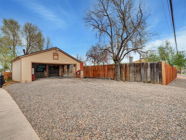 675 S Quivas St, Denver, CO 80223 - exterior space featuring fence, an outdoor structure, and a garage