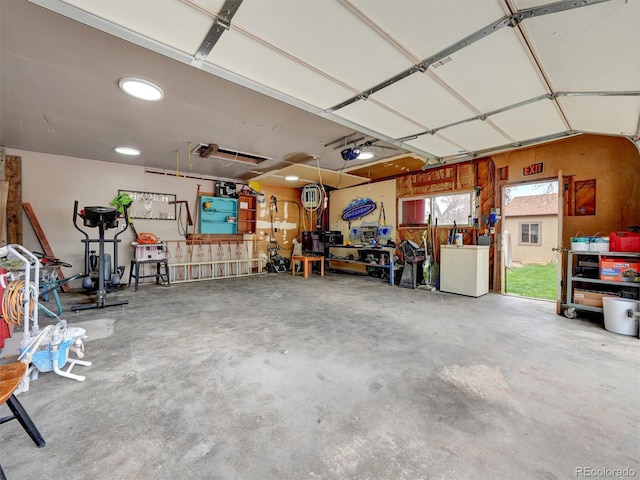 675 S Quivas St, Denver, CO 80223 - garage with a garage door opener and refrigerator