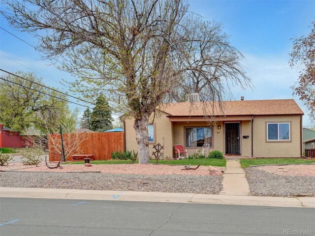 675 S Quivas St, Denver, CO 80223 - view of front of home featuring stucco siding and fence