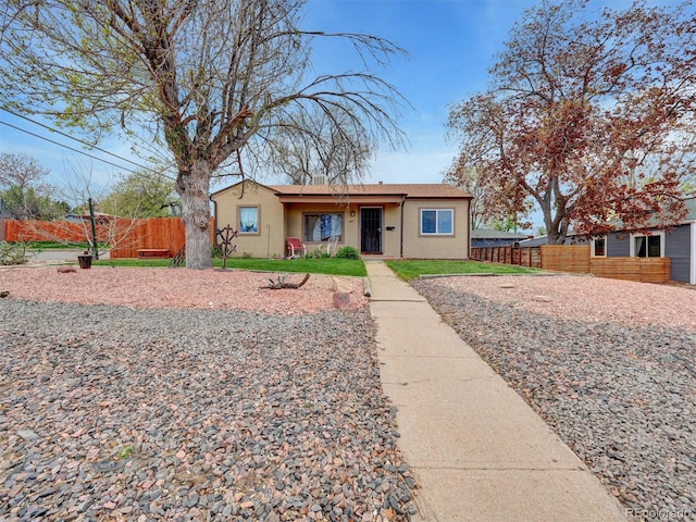 675 S Quivas St, Denver, CO 80223 - bungalow-style house featuring fence and stucco siding