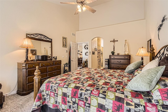 bedroom featuring carpet flooring, a towering ceiling, ceiling fan, and baseboards