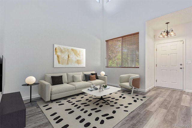 19466 E 59th Dr, Aurora, CO 80019 - living room with wood finished floors, a chandelier, and plenty of natural light