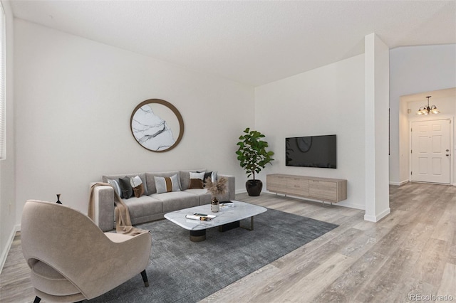 19466 E 59th Dr, Aurora, CO 80019 - living room featuring wood finished floors and a chandelier