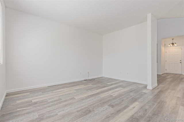 19466 E 59th Dr, Aurora, CO 80019 - empty room featuring light wood-style floors and a chandelier