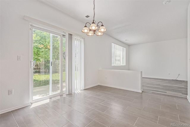 19466 E 59th Dr, Aurora, CO 80019 - empty room featuring plenty of natural light and a chandelier
