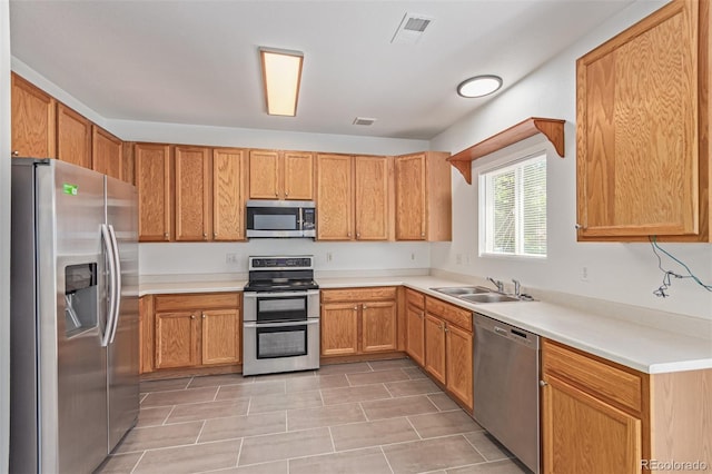 19466 E 59th Dr, Aurora, CO 80019 - kitchen featuring appliances with stainless steel finishes, light tile patterned floors, and light countertops
