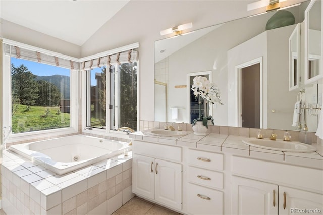 31402 N Bermuda Dunes Dr, Evergreen, CO 80439 - bathroom with vaulted ceiling, double vanity, a tub with jets, a mountain view, and tile patterned flooring