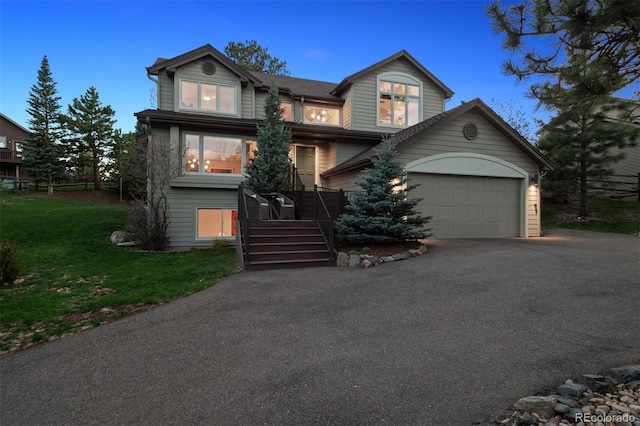 31402 N Bermuda Dunes Dr, Evergreen, CO 80439 - view of front of house with asphalt driveway, a front yard, and an attached garage