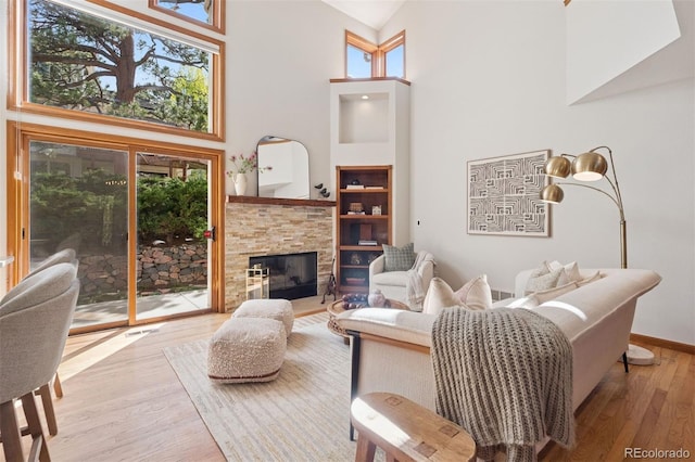 31402 N Bermuda Dunes Dr, Evergreen, CO 80439 - living room with a high ceiling, wood finished floors, and a fireplace