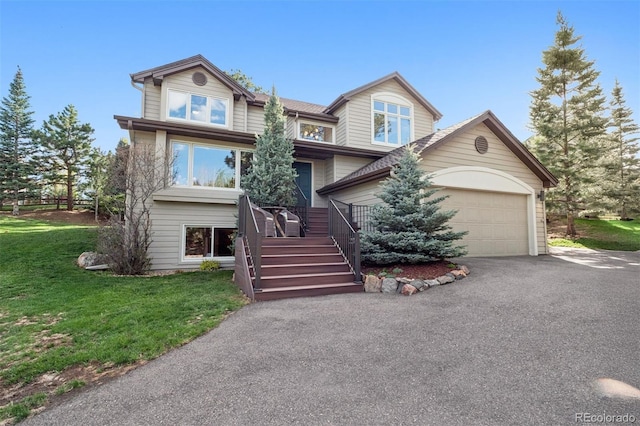 31402 N Bermuda Dunes Dr, Evergreen, CO 80439 - view of front of property with asphalt driveway, a front lawn, an attached garage, and stairs