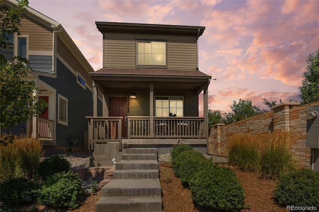 traditional-style house featuring covered porch
