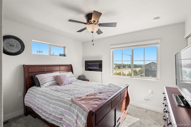 bedroom featuring baseboards, multiple windows, and carpet flooring