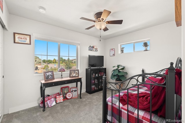 carpeted bedroom with baseboards and a ceiling fan