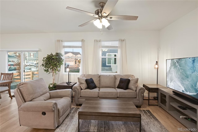 living room featuring light wood-type flooring and ceiling fan