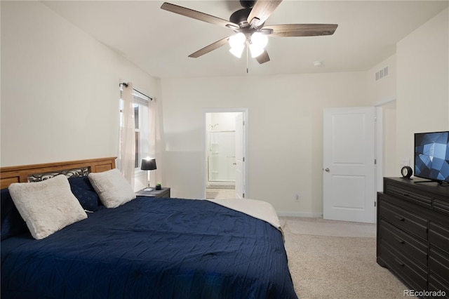 carpeted bedroom with ceiling fan and ensuite bathroom