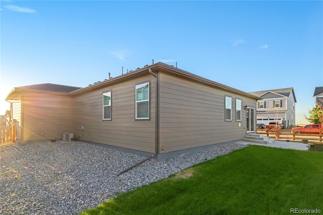 exterior space with a yard and central AC