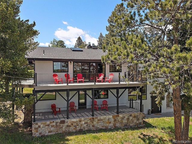 31756 Buffalo Park Rd, Evergreen, CO 80439 - back of property featuring a balcony, roof with shingles, and stucco siding