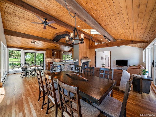 31756 Buffalo Park Rd, Evergreen, CO 80439 - dining room with wood ceiling, light wood finished floors, ceiling fan, rail lighting, and a chandelier