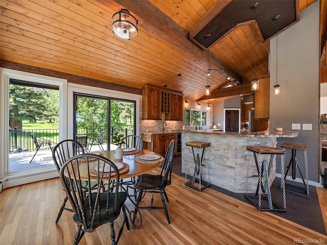 31756 Buffalo Park Rd, Evergreen, CO 80439 - dining space featuring wooden ceiling, lofted ceiling, healthy amount of natural light, and light wood-style floors