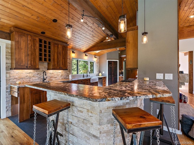31756 Buffalo Park Rd, Evergreen, CO 80439 - kitchen with wooden ceiling, wood finished floors, dishwasher, track lighting, and a peninsula