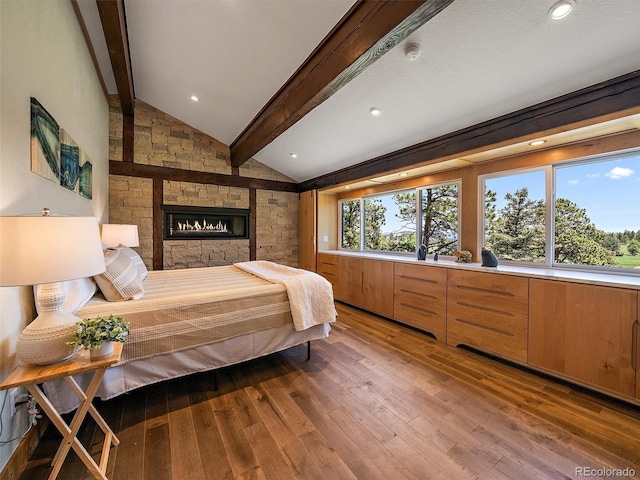 31756 Buffalo Park Rd, Evergreen, CO 80439 - bedroom featuring wood finished floors and a stone fireplace