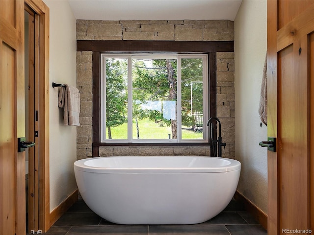 31756 Buffalo Park Rd, Evergreen, CO 80439 - full bath featuring a soaking tub, tile patterned floors, and baseboards