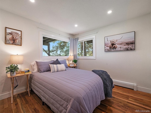 31756 Buffalo Park Rd, Evergreen, CO 80439 - bedroom with a baseboard heating unit, baseboards, wood finished floors, and recessed lighting
