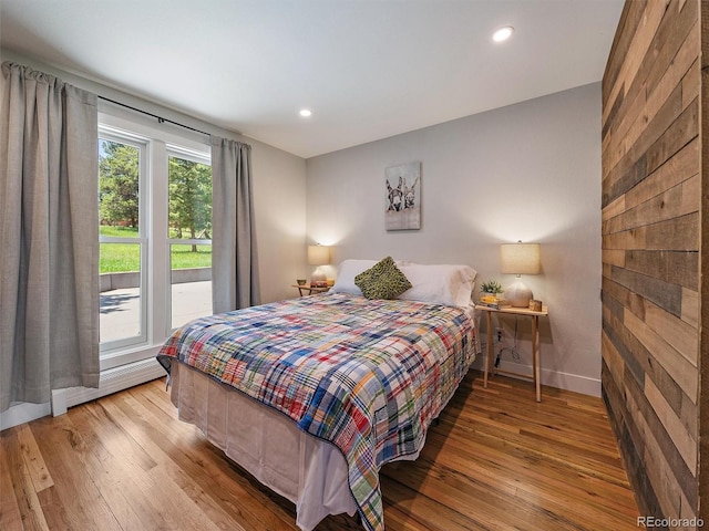 31756 Buffalo Park Rd, Evergreen, CO 80439 - bedroom with hardwood / wood-style floors, a baseboard radiator, baseboards, and recessed lighting
