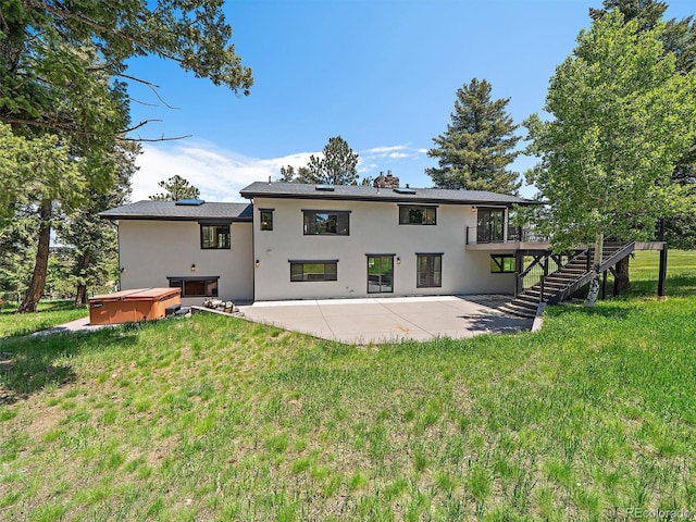 31756 Buffalo Park Rd, Evergreen, CO 80439 - back of property featuring a hot tub, a patio, stairs, stucco siding, and a wooden deck
