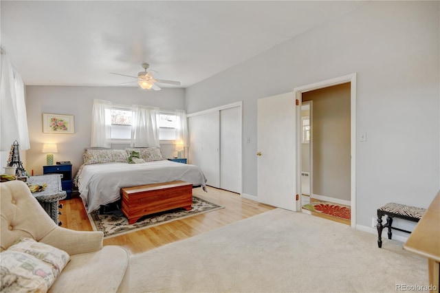 bedroom featuring a closet, baseboards, ceiling fan, and wood finished floors