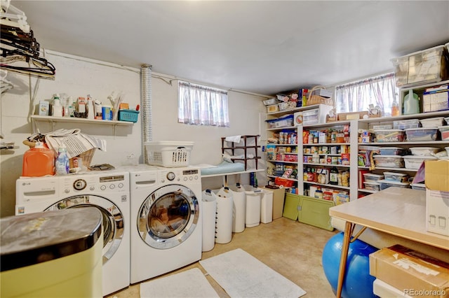 laundry area with washing machine and dryer and healthy amount of natural light