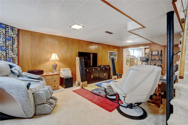 carpeted living room with wooden walls