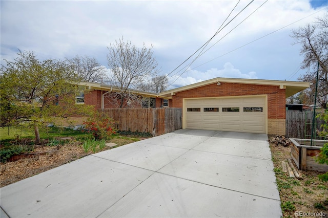 view of front facade with brick siding, fence, and a garage