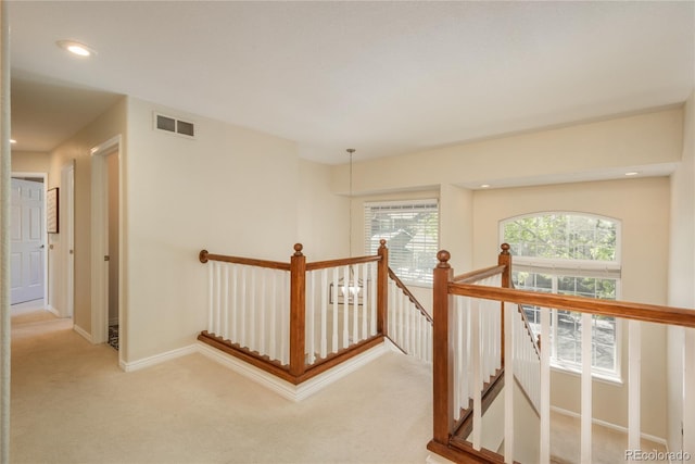 hallway featuring an upstairs landing, carpet, baseboards, and recessed lighting