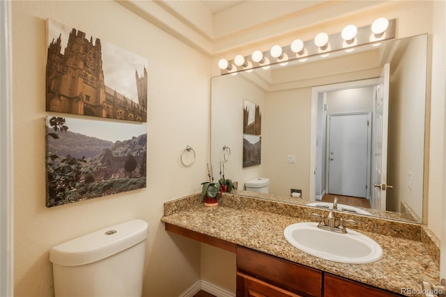 half bath featuring toilet and vanity