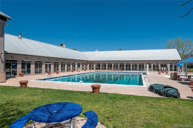 community pool featuring a yard and a patio
