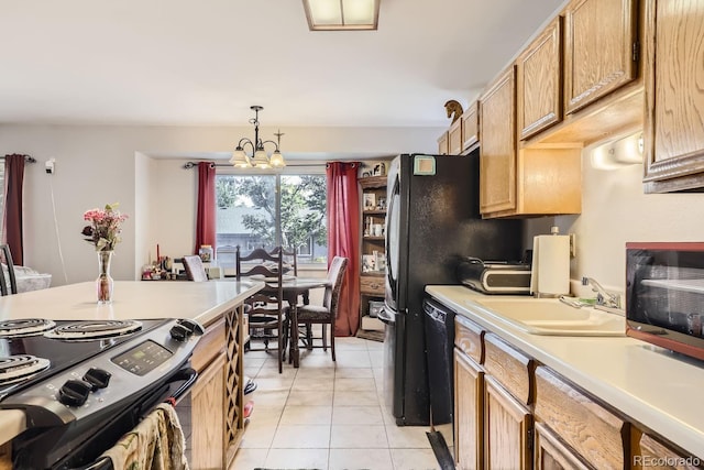 kitchen featuring light tile patterned flooring, a sink, light countertops, hanging light fixtures, and electric stove