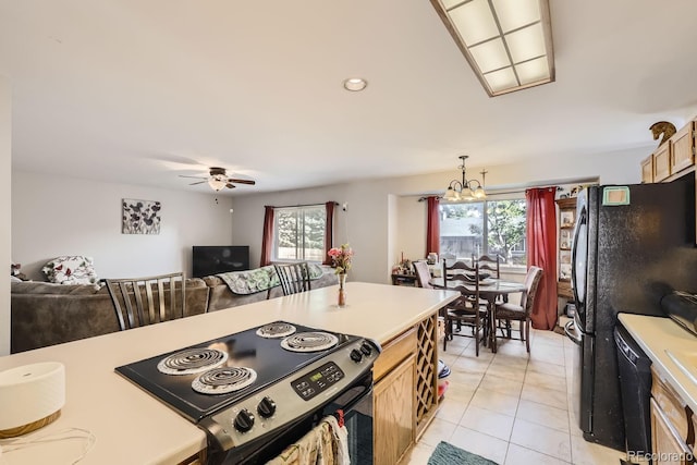 kitchen featuring pendant lighting, light countertops, and open floor plan