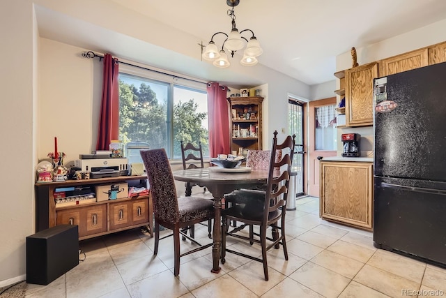 dining room featuring a healthy amount of sunlight, light tile patterned floors, and a chandelier