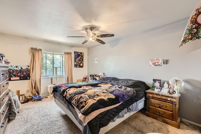 carpeted bedroom with a ceiling fan and baseboards