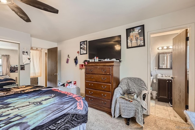 bedroom featuring a ceiling fan and connected bathroom