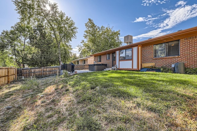 view of yard featuring a fenced backyard and a hot tub