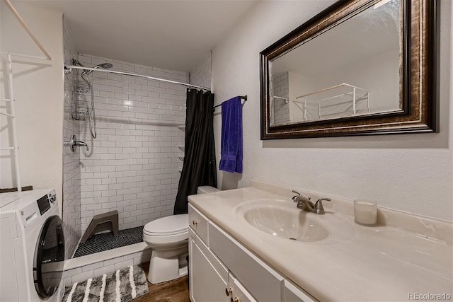 bathroom featuring vanity, washer / clothes dryer, toilet, and curtained shower