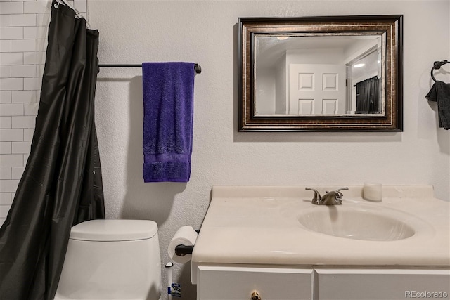 bathroom featuring vanity, toilet, and curtained shower