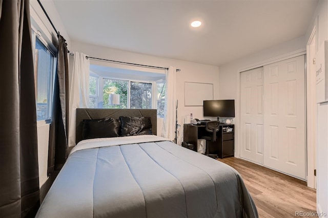 bedroom featuring a closet and light wood-type flooring