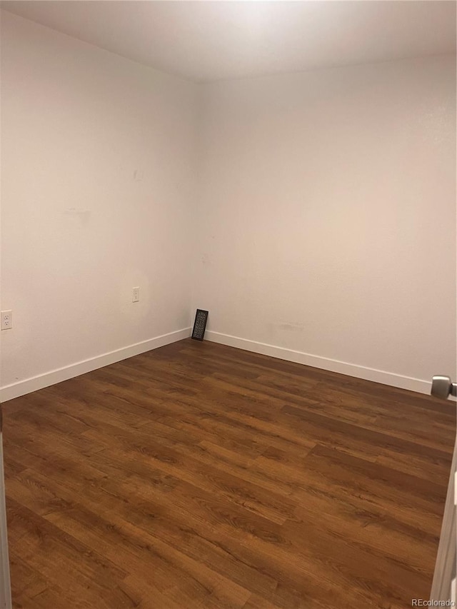 empty room with dark hardwood / wood-style floors