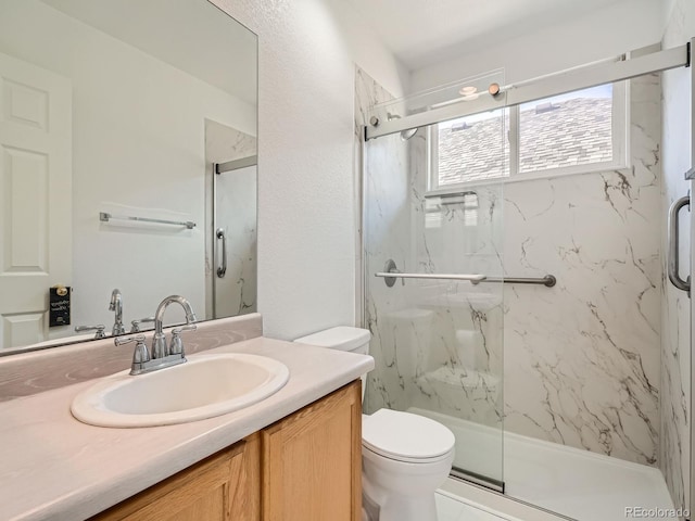 bathroom with vanity, toilet, and walk in shower