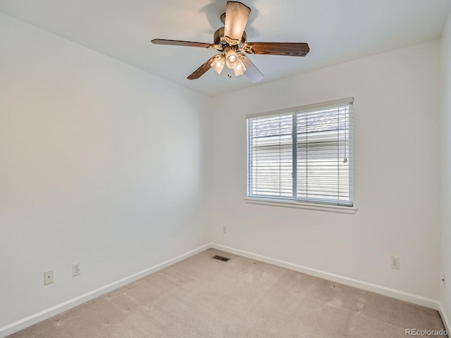 empty room featuring light carpet and ceiling fan