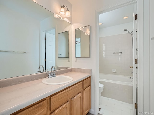 full bathroom featuring vanity, toilet, and tiled shower / bath