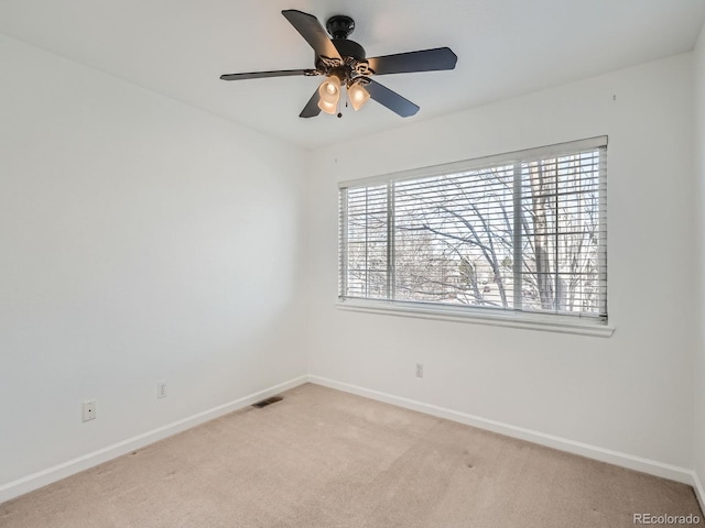 empty room with light colored carpet and ceiling fan